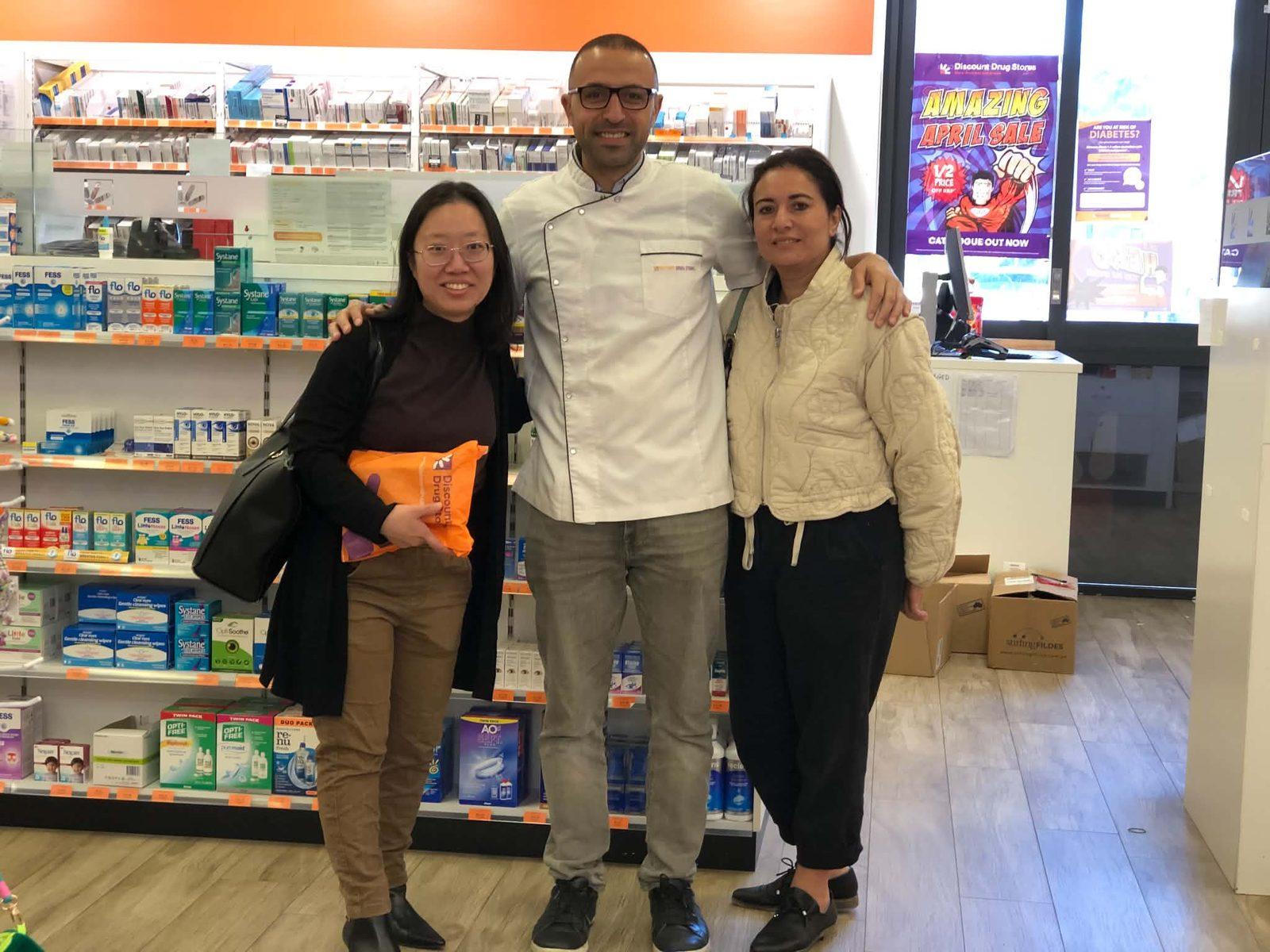 PBAC founder alongside owners inside a Discount Drug Stores pharmacy